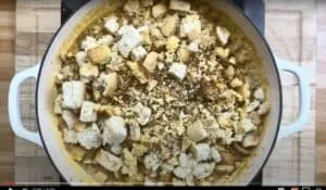 Pot of seasoned bread cubes for stuffing preparation. Perfect for holiday meals or comforting side dishes.